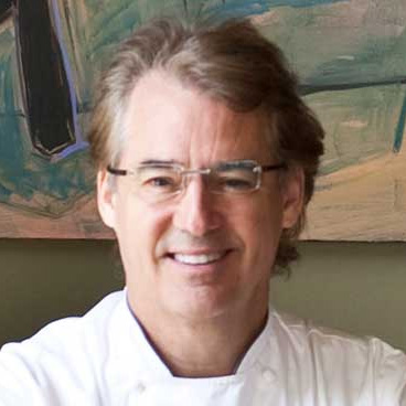 robert del grande smiling in his chef uniform